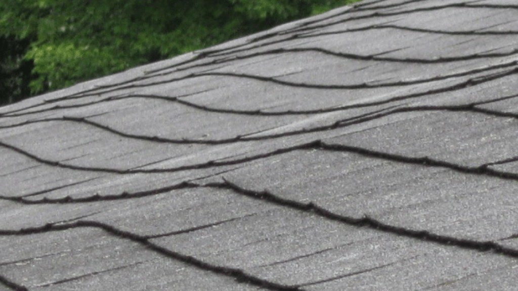 Sagging roof deck on a home, indicating structural damage.