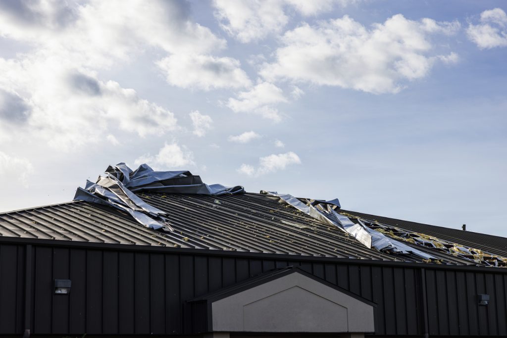 Damaged House Roof Twisted Shingle In Residential Area Hurricane Aftermath In Small Town Perry North Florida