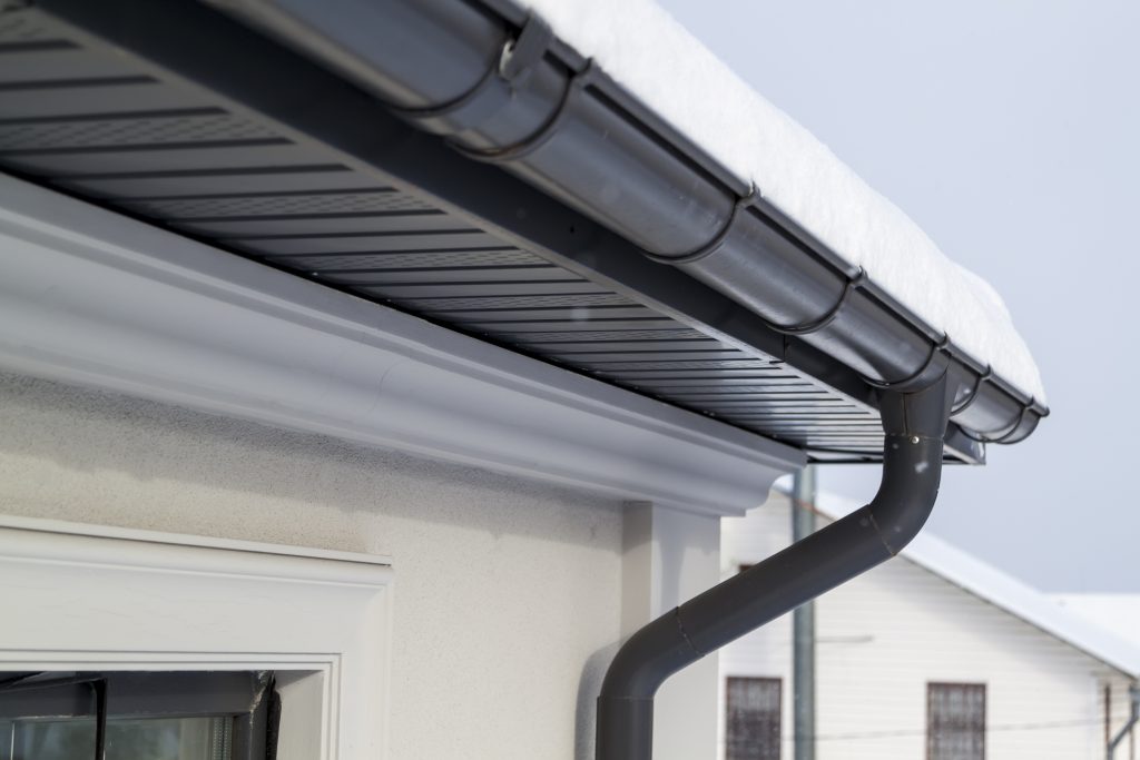 Corner Of The House With New Gray Metal Tile Roof And Rain Gutter At Winter Metallic Guttering System Guttering And Drainage Pipe Exterior